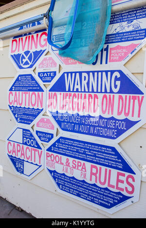 Swimming poolside warning, rules and safety signs and notices for swimmers using the pool Stock Photo