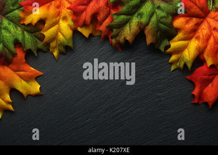Autumn leaves on a dark slate background Stock Photo