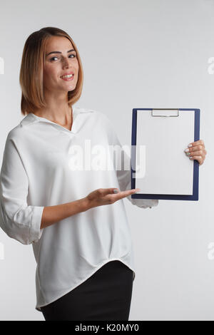 Portrait young businesswoman showing blank clipboard. Agent. Stock Photo