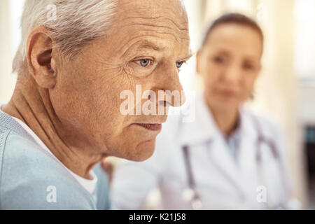 Sad cheerless man thinking about his life Stock Photo