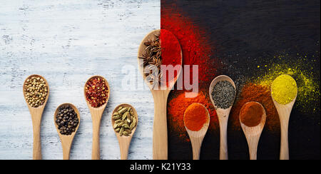 Wooden spoon filled with spices, herbs, powders and ground spices Stock Photo