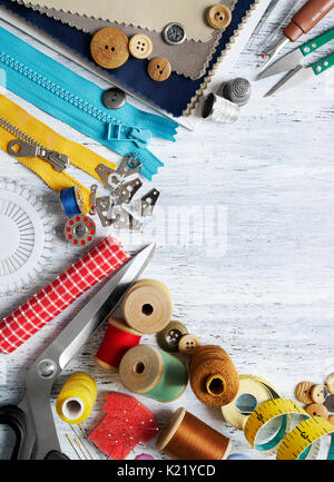 Sewing tools and accessories on white painted wooden background Stock Photo