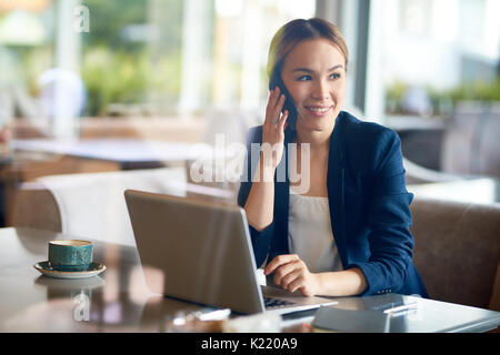Pretty Entrepreneur Working at Cafe Stock Photo