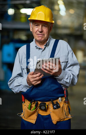 Senior Worker Posing with Digital Tablet Stock Photo