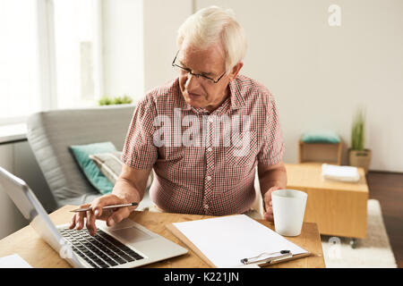 Senior Man Working with Laptop at Home Stock Photo