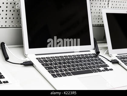 A modern computer is a laptop, put up for sale in a shop window. Stock Photo