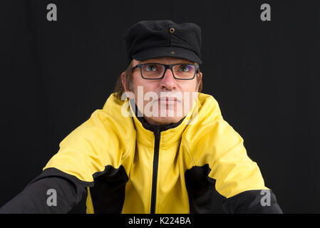 attractive candid european middle-aged male with hat and glasses Stock Photo