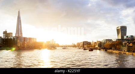 UK, London, Dramatic sky over the city skyline and River Thames at sunset, with view of the Shard and the Walkie Talkie tower Stock Photo
