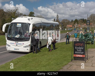 Day trippers boarding a bus home outside the Ryedale Folk Museum at Hutton le Hole Stock Photo