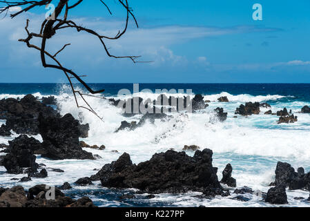 Surf hitting volcanic rocks on Maui, Hawaii Stock Photo