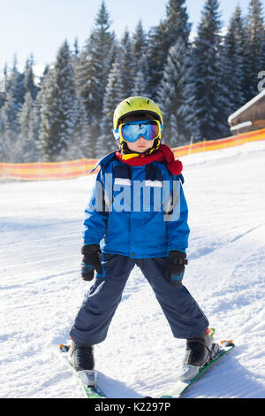 Cute little boy, skiing happily in Austrian ski resort in the mountains, wintertime Stock Photo