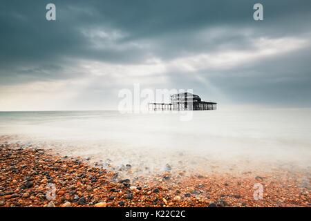 Abandoned (after fire) West pier in Brighton in gloomy day, United Kingdom