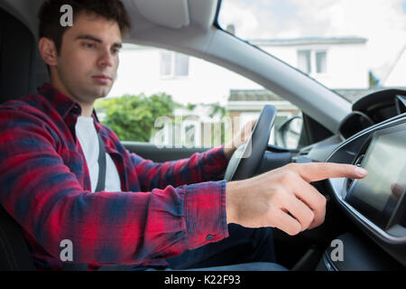 Male Driver Using Touchscreen In Car Stock Photo