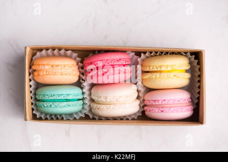 Sweet macarons. Different french cookies macaroons in a paper box. Stock Photo