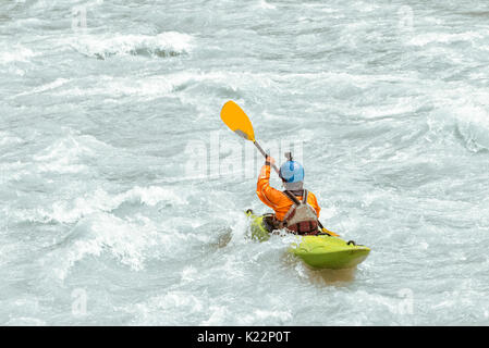 Kayaker paddling in white water rapids,  with copy space Stock Photo