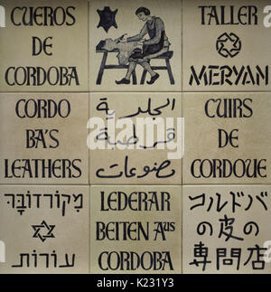 Ceramic panel in different languages announcing the sale of products made in traditional leather from Cordoba. Jewish Quarter. Cordoba. Andalusia. Spain. Stock Photo