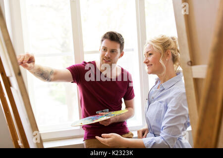 artists with palette and easel at art school Stock Photo