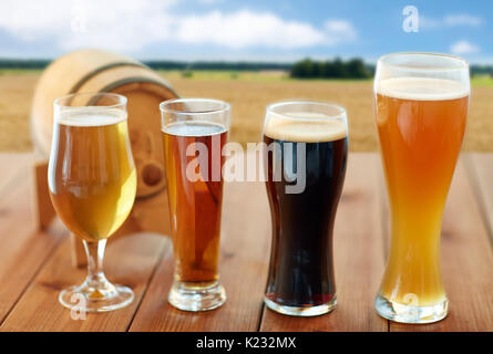 different types of beer in glasses on table Stock Photo