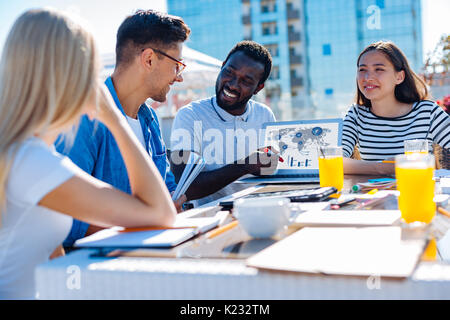 Happy minded international students discussing university project Stock Photo