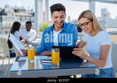 Cheerful groupmates working on project together Stock Photo