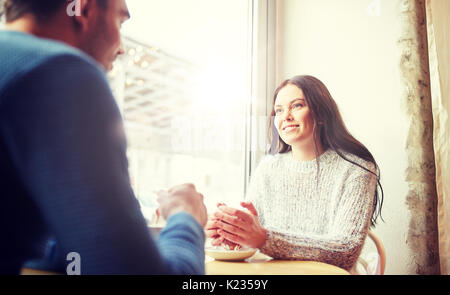 happy couple drinking tea and coffee at cafe Stock Photo