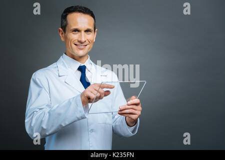 Cheerful man with invisible technological devise smiling Stock Photo