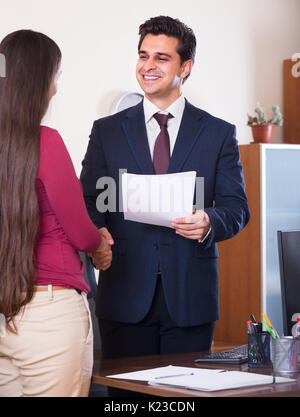 Smiling chief manager hiring female assistant after job interview on permanent basis Stock Photo