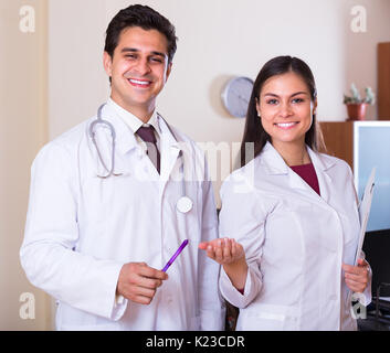 Portrait of two smiling therapeutists with stethoscope in private clinic Stock Photo