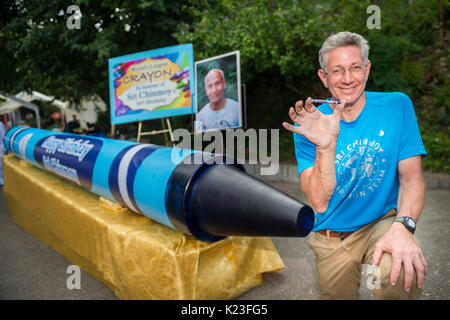 New York, US. 27th Aug, 2017. The world record holder of the Guinness World Records, Ashrita Furman (62), presents the world's largest crayon in the district of Queens in New York, US, 27 August 2017. It is 5.22 metres long and 46 centimetres thick and weighs around 900 kilos. Furman presented the blue crayon in honour of his spiritual teacher Sri Chinmoy (1931-2007) on the occasion of his 86th birhtday. · NO WIRE SERVICE · Photo: Jowan Gauthier/spontaneousbeauty.com/dpa/Alamy Live News Stock Photo