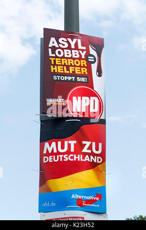 Berlin, Germany. 28th August 2017. Party political posters for far-right neo-Nazi NPD party, National Democratic Party of Germany (top) with message, 'Asylum Lobby are Terrorist Helpers', and the far-right Alternative for Germany party, AfD , with message 'Courage to Germany' in Eastern district of Berlin for Federal elections on 24th September 2017. Credit: Iain Masterton/Alamy Live News Stock Photo