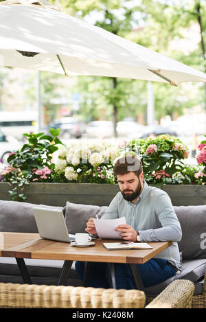 Busy Businessman Working in Cafe Outdoors Stock Photo