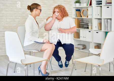 Obese Young Woman Crying in Meeting with Psychiatrist Stock Photo