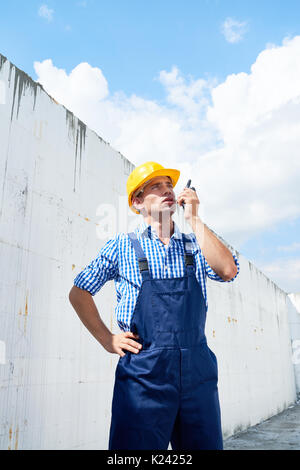 Construction Foreman Using Portable Radio Stock Photo