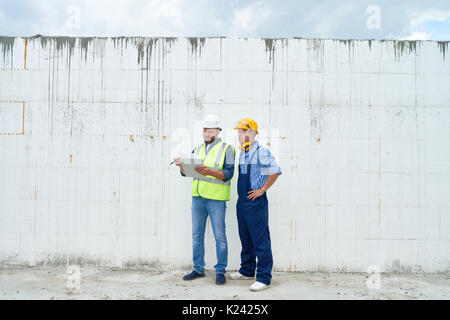 Construction Workers Discussing Building Stock Photo