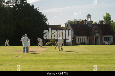 Village cricket at Benenden in Kent on a sunny summers evening on the village green Stock Photo