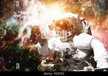 Astronaut in outer space against the backdrop of the outer space. Elements of this image furnished by NASA Stock Photo