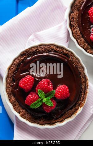 Chocolate raspberry tarts mint leaves Stock Photo