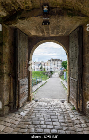 View of the town of Blaye, a commune in Gironde, Nouvelle-Aquitaine, France, through the entrance gates of La Citadelle de Blaye (Citadelle de Vaubon) Stock Photo