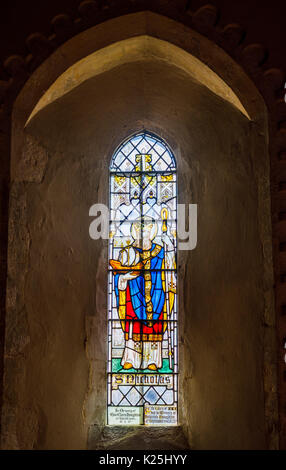 Stained glass window in St Nicholas church, an historic ancient church in Compton, a village near Guildford, Surrey, south-east England, UK Stock Photo