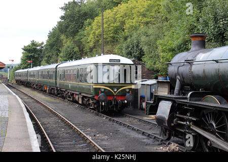 Two preserved heritage diesel multiple unit trains in BR green livery and steam train at Bewdley railway station on the Severn Valley Railway, England Stock Photo