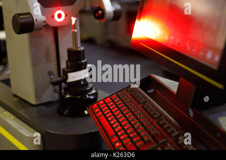 Quality test of milling cutter by professional tool presetting and measuring machine. Selective focus. Stock Photo