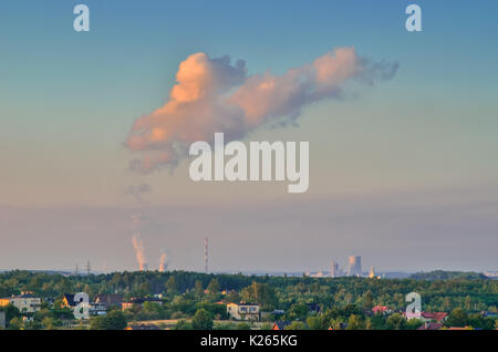 Urban summer landscape. View of houses and smoking chimneys. Stock Photo