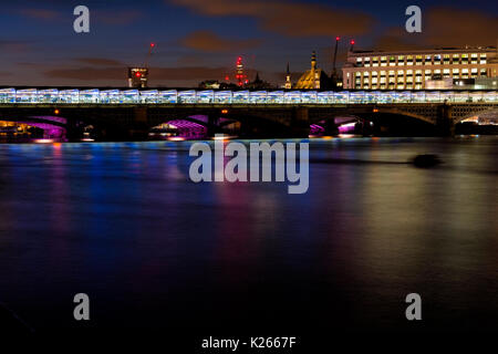 Blackfriars Bridge at night. The solar panels across the whole station are a unique feature of this newly refurbished station. Stock Photo