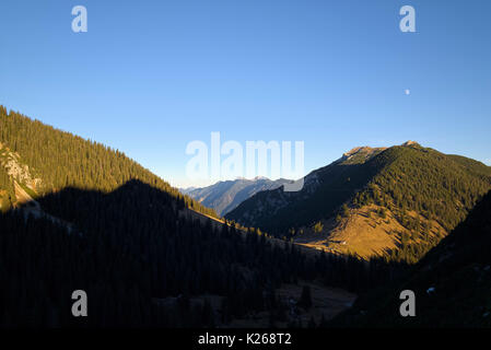 view of Stepberg alp and mountain Kramerspitz and mountain shaped shadow, Bavaria, Germany Stock Photo