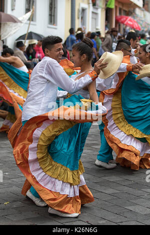 June 17, 2017 Pujili, Ecuador: indigenous couple dancing in colonial style dress at the Corpus Christi annual parade