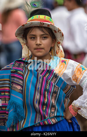 June 17, 2017 Pujili, Ecuador: young indigenous girl in bright color traditional clothing at Corpus Christi parade dancing in the street Stock Photo