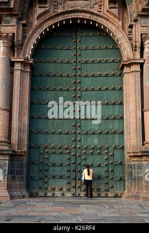 Person at main door of Cusco Cathedral, Plaza de Armas, Cusco, Peru, South America Stock Photo