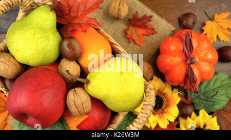 Autumn Fall overhead with seasonal fruit and nuts on a rustic wood background. Stock Photo
