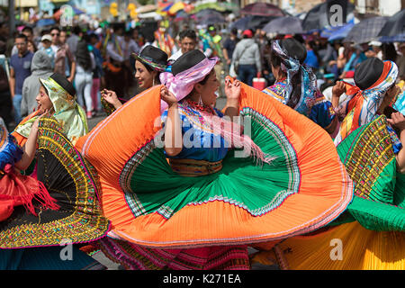 June 17, 2017 Pujili, Ecuador: female dancer group  in traditional clothing in motion at the Corpus Christi annual parade