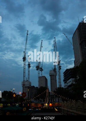 Cranes at dusk in London Stock Photo